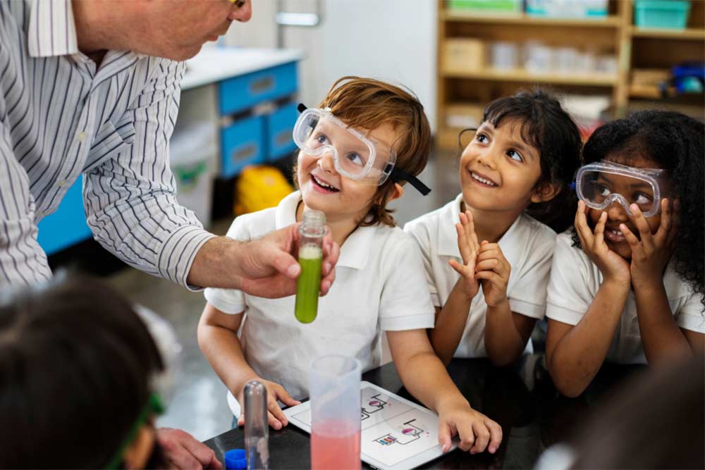 children with teacher in science class